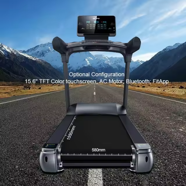 Treadmill placed on a mountain road with a blue sky and snowy peaks; overhead touchscreen display shows specs like a 15.6-inch color screen, AC motor, Bluetooth FitApp.