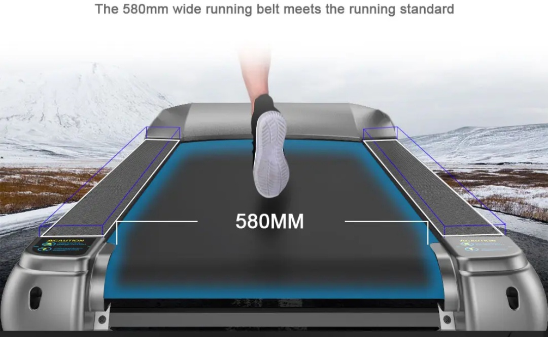 Treadmill running belt labeled 580 mm wide, with a runner’s foot landing on it and side rails visible in a snowy outdoor scene.
