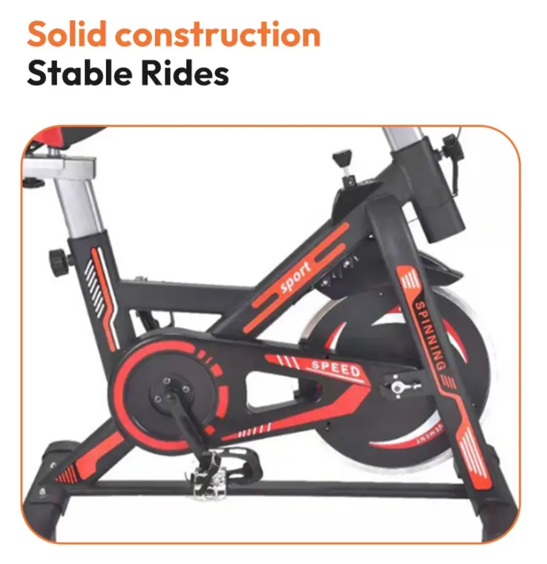 Screenshot_20260627_081954_Alibabacom - Tecno-Train Indoor stationary bike with a sturdy black frame and red accents, showing a large flywheel and pedals, labeled SPORT and SPEED as part of the design.